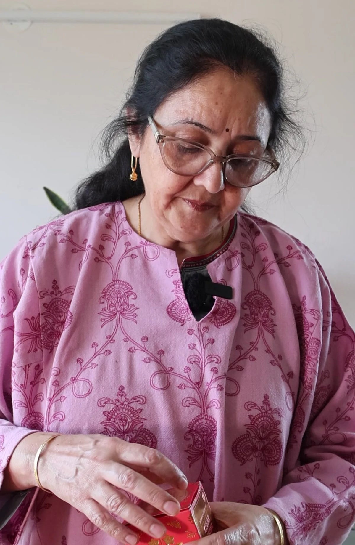 Ma holding a Kehwah pack at home
