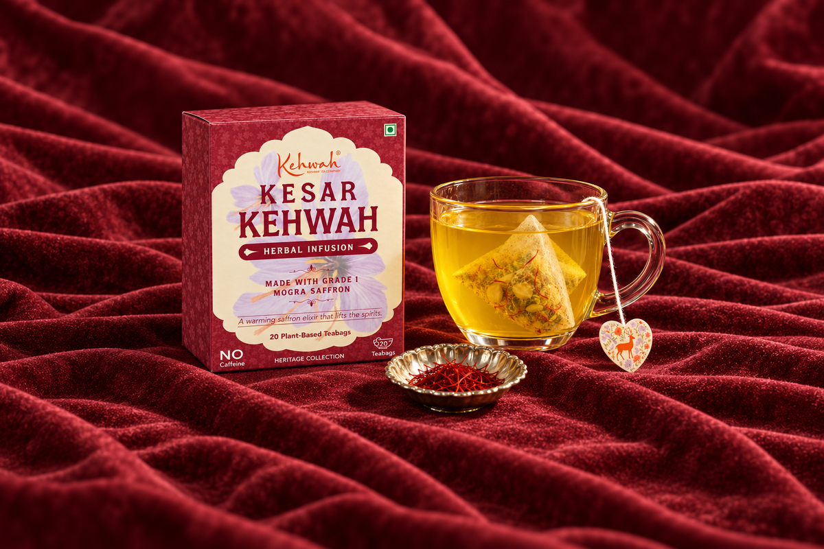 Two golden cups of Kesar Kehwah beside its sachet on a colourful table