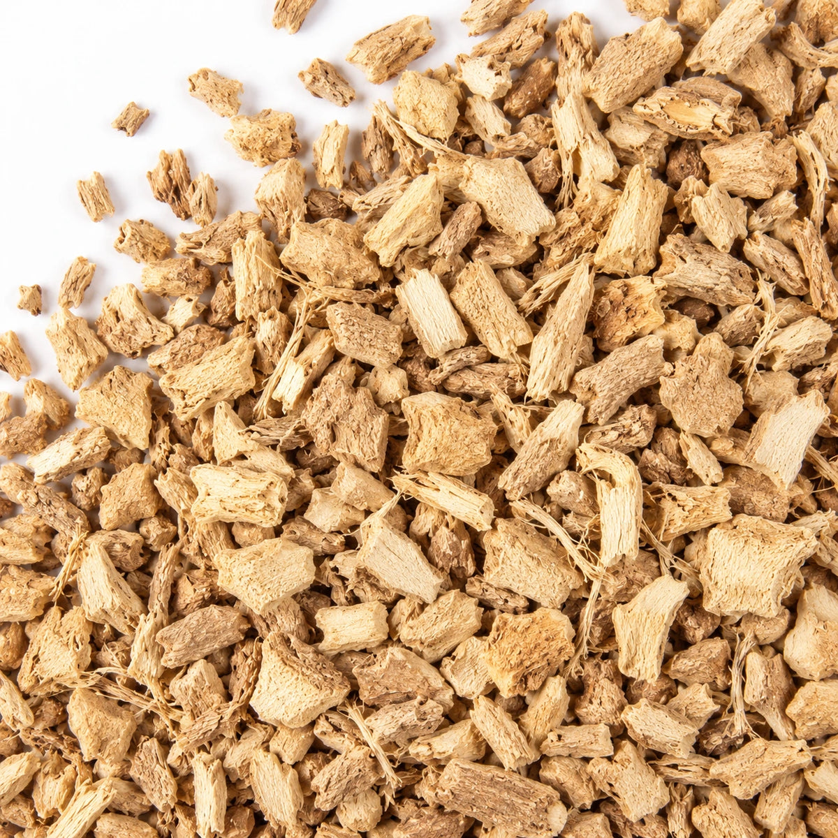 Cut dried ginger on a white background