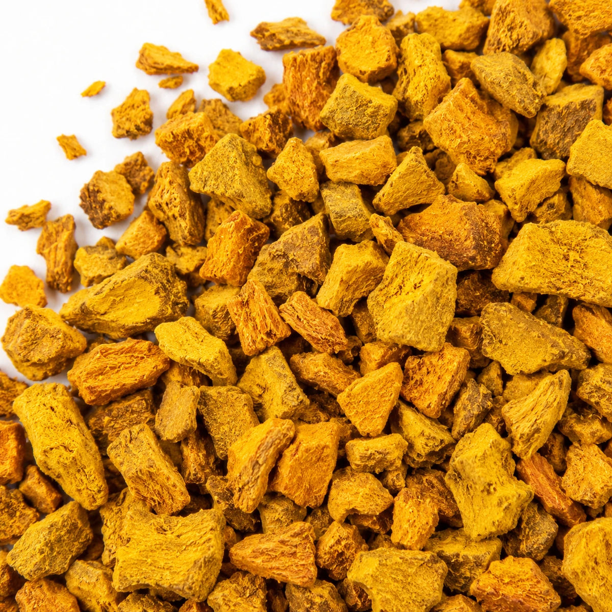 Cut dried turmeric on a white background