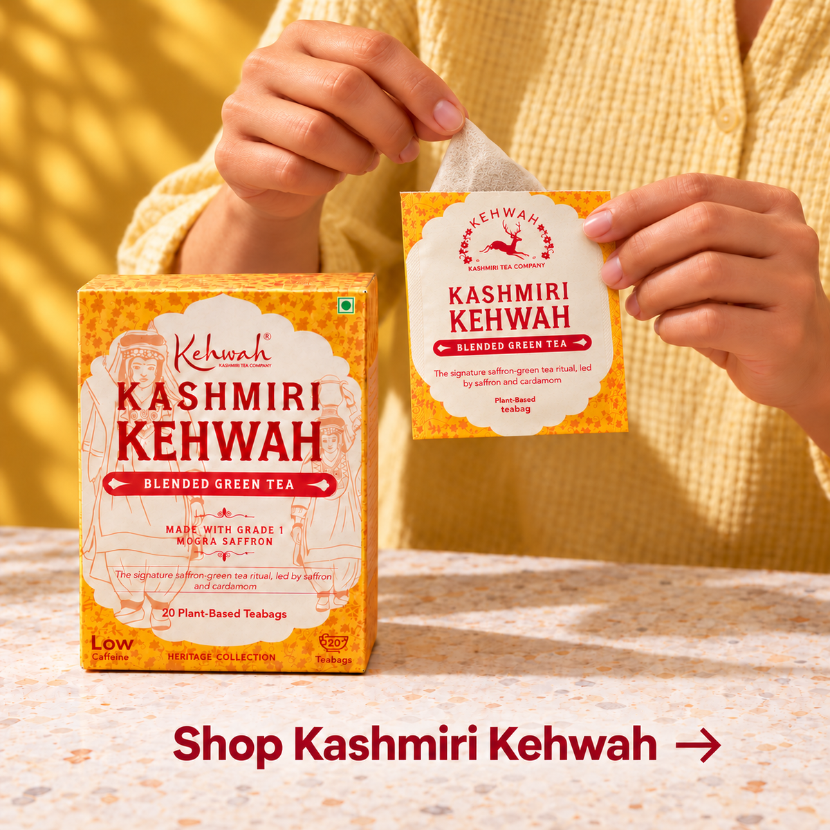 A pyramid tea bag being drawn from a Kashmiri Kehwah sachet.
