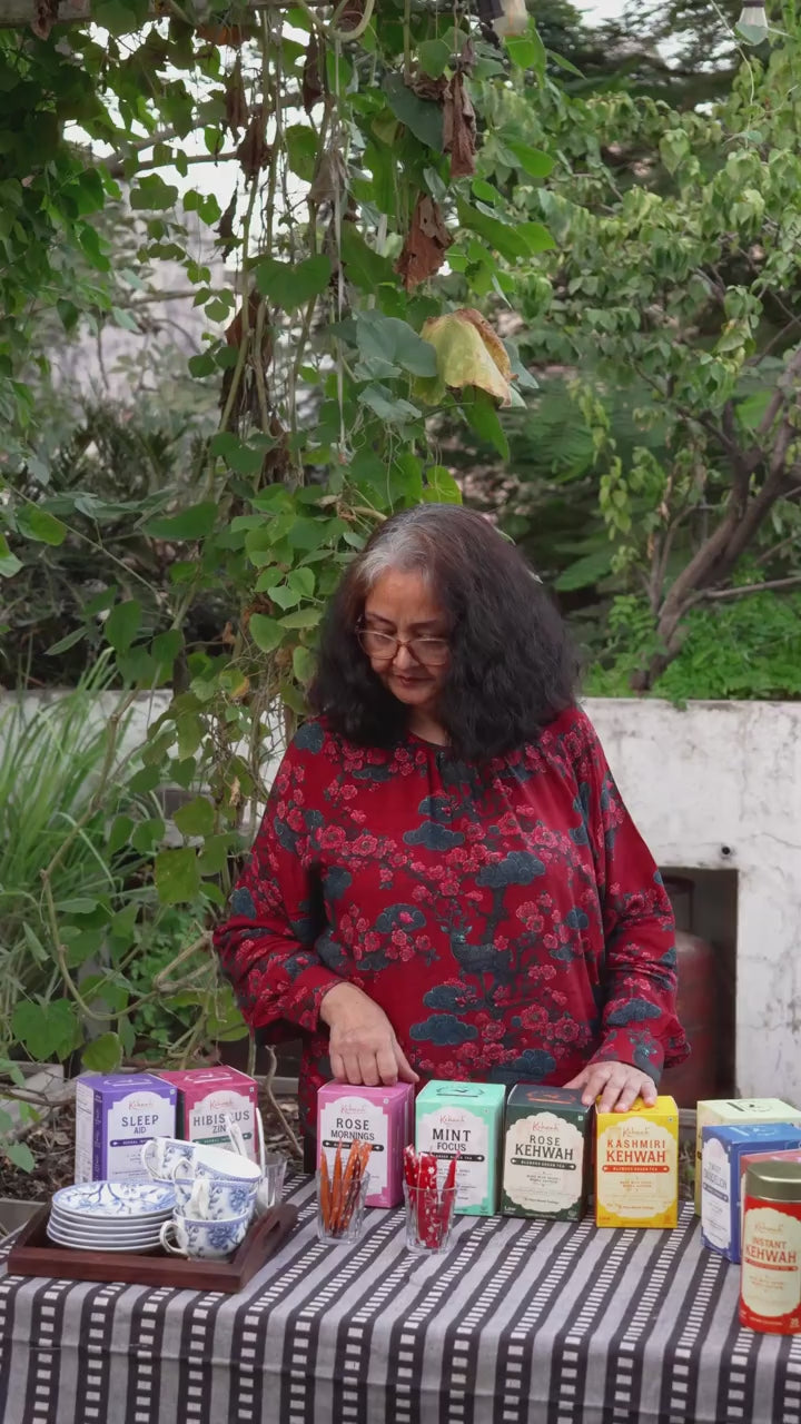 Ma arranging Kehwah at a garden table. Silent film.