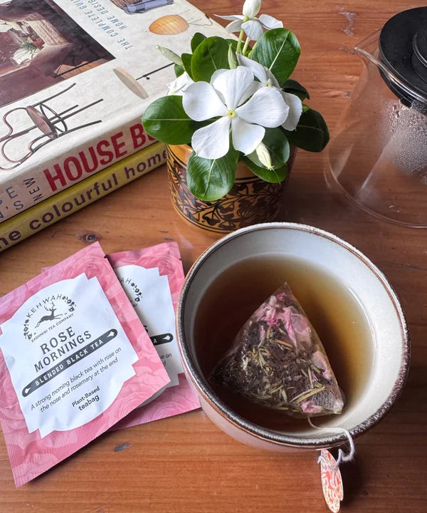 Rose Mornings steeping beside its pink sachet and flowers