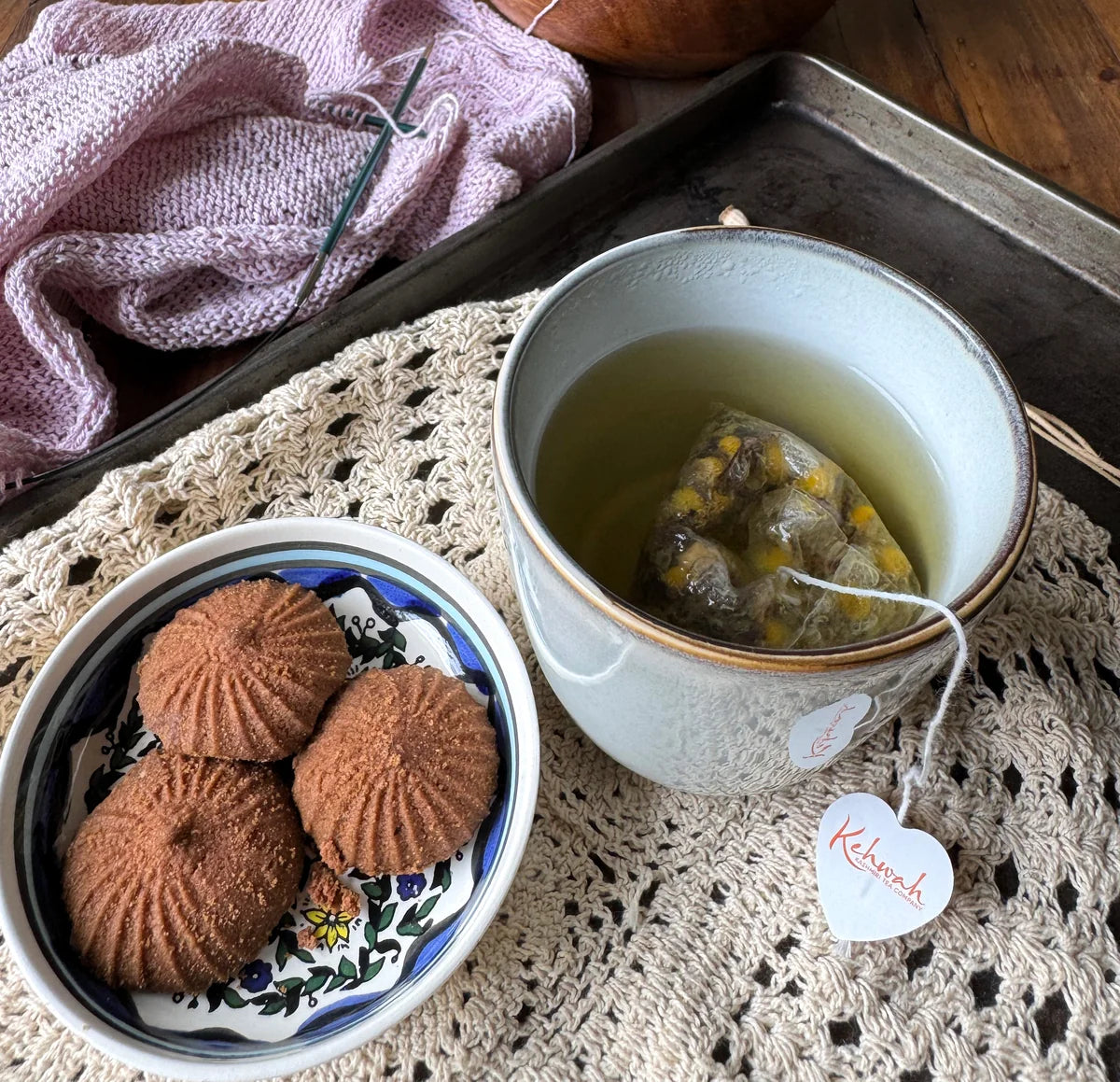 Sleep Aid steeping beside biscuits on a lace-covered table
