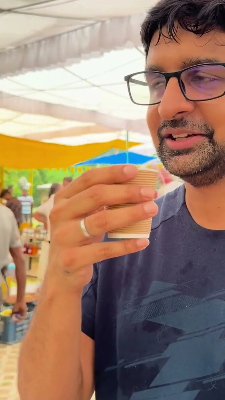 A guest taking a first sip of Kehwah at a public tasting