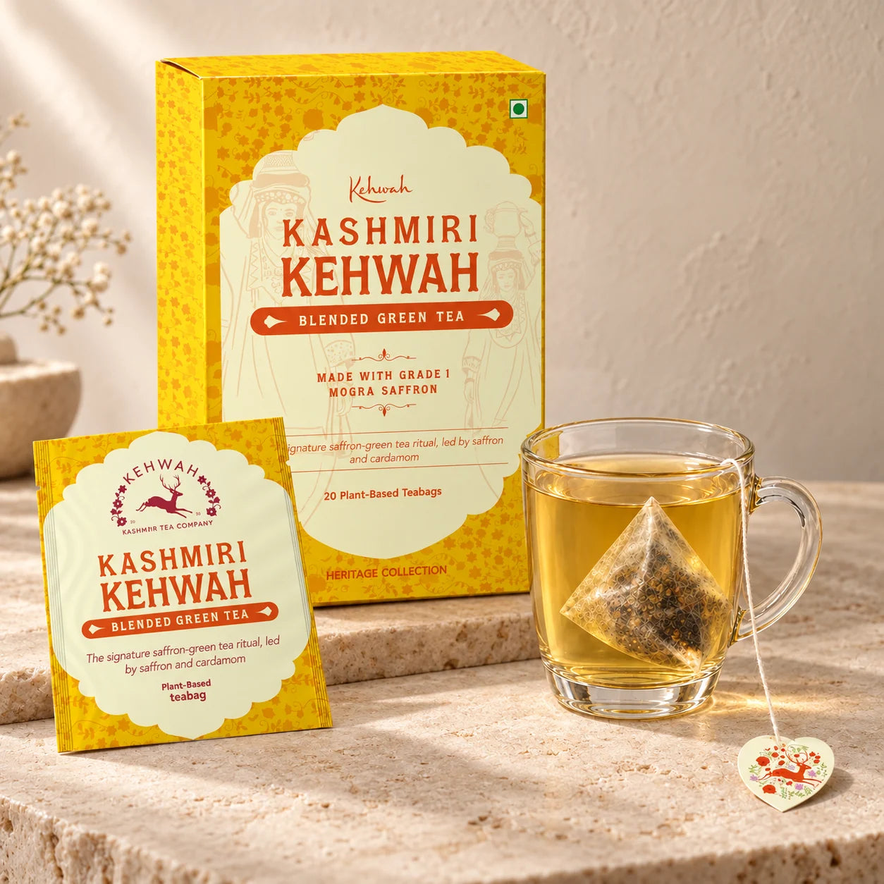 Kashmiri Kehwah yellow carton, matching sachet and golden tea on cream stone