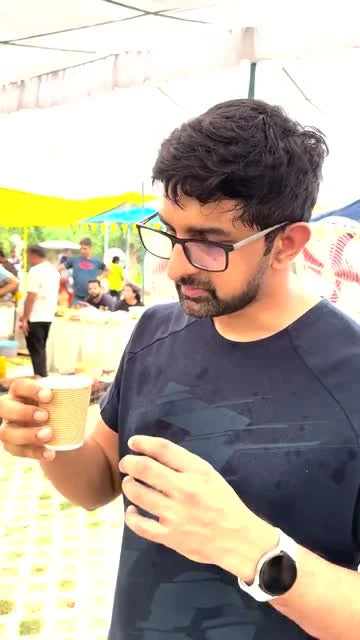 A guest taking a first sip of Kehwah at a public tasting